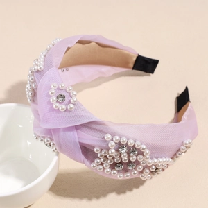 Detail of light purple mesh headband featuring pearl flowers and sparkling crystal knot