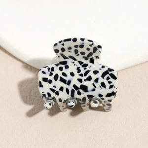 Detail view of Dalmatian print acetate hair claw clip with black and white spots and metal spring
