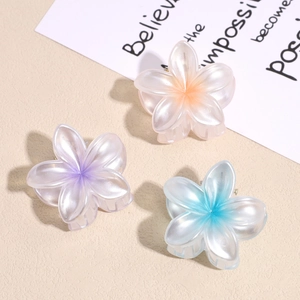 Three gradient floral hair claws with pearlescent finish in pink, violet, and blue colors