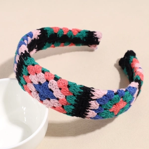 Close-up of handmade crochet headband showing intricate bohemian floral knit texture