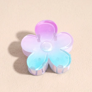 Detail view of a small gradient plumeria hair claw with purple to blue matte finish