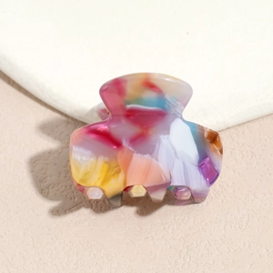 Close-up of a colorful watercolor acetate hair claw clip with smooth polished finish