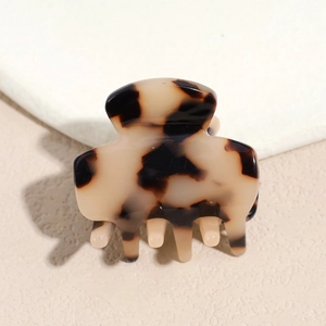 Macro view of vintage tortoiseshell hair claw clip with glossy acetate finish