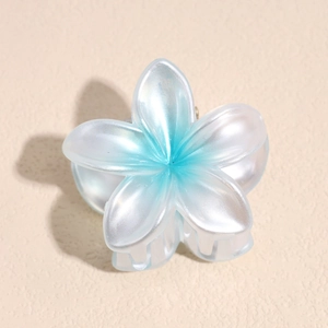 Detail of floral hair claw clip featuring blue and white pearlescent gradient finish