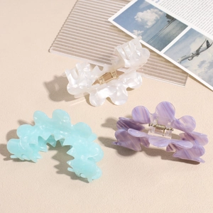 Three-piece acetate claw clip set with wave petal design in white, blue and purple