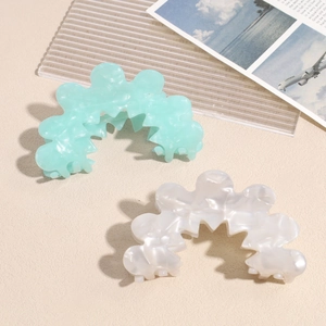Elegant wavy acetate hair claws in mint green and pearl white marble texture