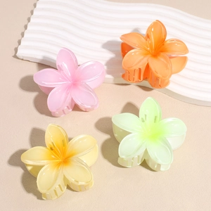 Set of four colorful plumeria flower hair claws with a matte resin finish for women