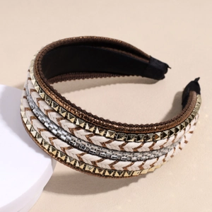 Detail of wide headband featuring white braided rope, gold studs, and sparkling rhinestones