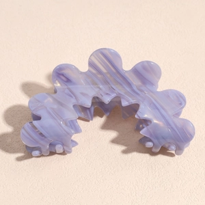 Detailed view of light purple marble pattern acetate hair claw with wave design