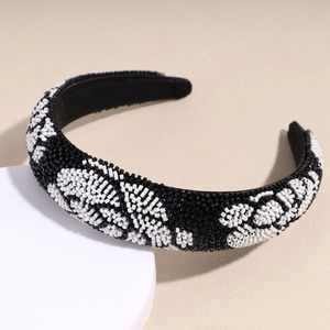 Close-up of handmade baroque beadwork on a luxury sponge headband with flower texture