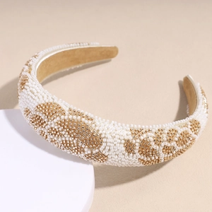 Detailed macro view of handmade baroque pearl headband with intricate golden bead embroidery