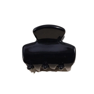 Classic black acetate hair claw clip with glossy finish and strong grip teeth on white background