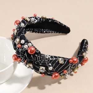 Detailed view of Halloween headband with silver spider web, pearls and rhinestones