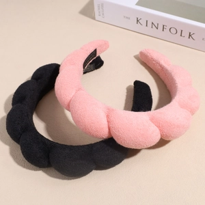 Serre-têtes en éponge rose et noir avec un design ondulé pour un effet volumineux