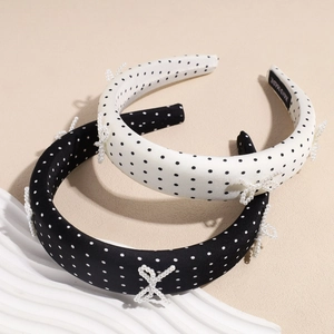Polka dot padded headband with pearl bow embellishment in black and white styles