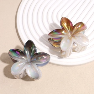 Elegant iridescent plumeria flower hair claws in gold-pink and blue-purple finish