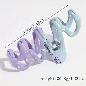 Detail view of large wave hair claw clip with purple gradient and white ink spray design