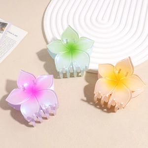 Three gradient floral hair claws in purple green and yellow with a matte finish