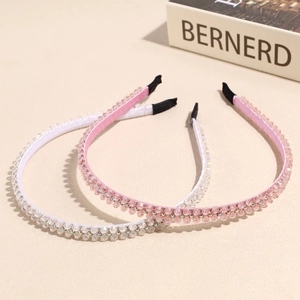 Elegant double-row crystal headband set with pink and white rhinestones on beige background