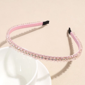 Detailed view of pink crystal double-row headband with sparkling rhinestones decoration