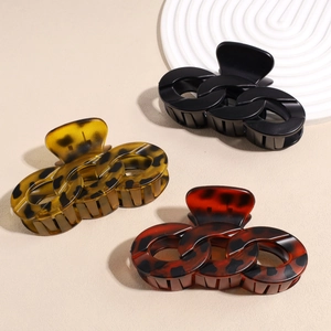 Three large chain-link hair claws in leopard tortoiseshell and black finish
