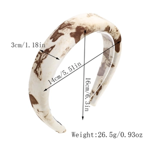 Detail showing cow print pattern fabric and dimensions on wide sponge headband
