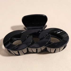 Close-up of classic black large hair claw clip with triple link chain design and firm teeth