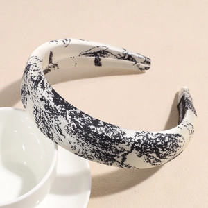 Close-up of beige Toile de Jouy satin headband with vintage black butterfly ink patterns