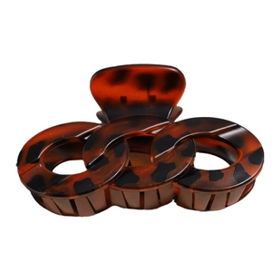 Retro tortoise shell hair claw clip with interlocking rings design on white background