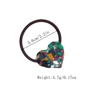 Detail showing acetate heart hair tie with colorful rhinestones and elastic band dimensions