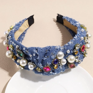 Detail of blue denim headband with vintage knotted pearls and sparkling rhinestones
