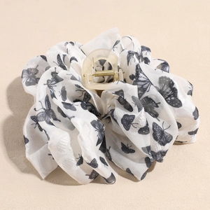 Detail view of the black and white butterfly print mesh fabric on large hair claw clip