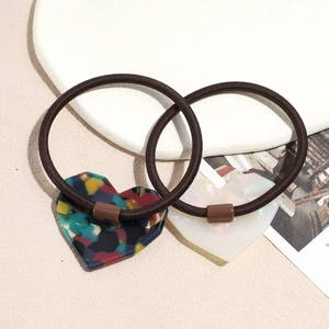 Elegant set of two heart-shaped resin hair ties with marble texture and pearlescent finish