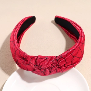 Detail of red wide knotted headband with black spider web pattern for Halloween theme