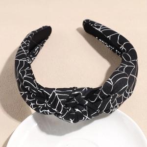 Detail of black knot headband with silver spider web print for Halloween party