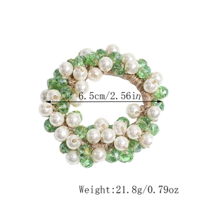Détail de l'élastique à cheveux orné de perles nacrées et de cristaux vert clair
