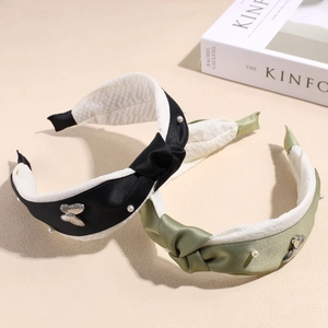 Elegant satin headband set with white pearls and silver butterfly accents in black and green