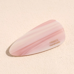 Detail of pink marble pattern duckbill hair clip with golden France Handmade text