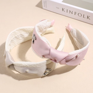 Elegant wide satin pearl headbands with bow design in pink and champagne colors