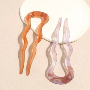 U-shaped acetate hair fork set with wavy design and sparkling rhinestone accents
