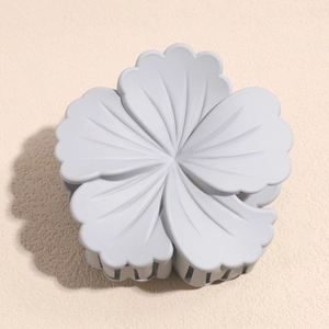 Top view of matte light blue flower hair claw clip with detailed petal texture