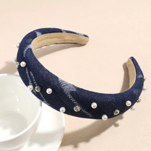 Close-up of denim headband with imitation pearls, silver rhinestones and beige velvet lining
