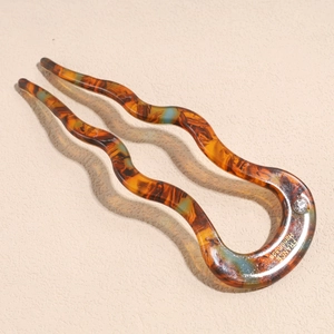 U-shaped tortoise shell hair pin with wavy double forks and a sparkling rhinestone