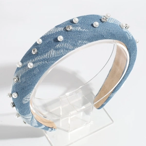 Close-up of denim headband decorated with white faux pearls and sparkling rhinestones