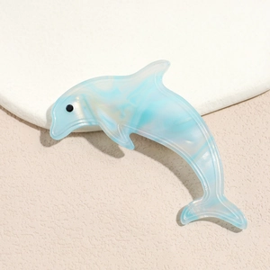 Detail of blue marble acetate dolphin hair clip with a smooth polished surface and sleek finish