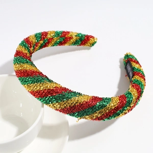 Detail of handmade Christmas sponge headband with festive red green and gold glitter stripes