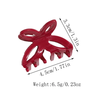 Detail view of red butterfly bow hair claw clip with size measurements and weight data