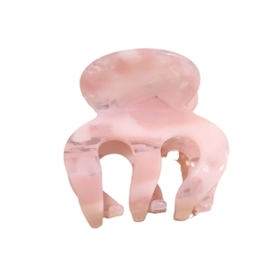 Pink marble texture acetate hair claw clip for women on a clean white background