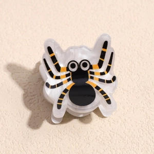 Close-up of spider hair claw with black and yellow stripes for Halloween hair accessory