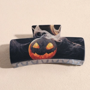 Detail of Halloween pumpkin lantern print on a large square black hair claw clip